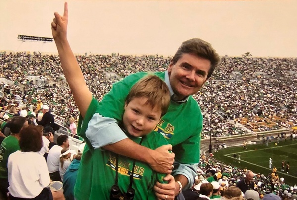 Jim hugs his son Danny posing together in Notre Dame Stadium