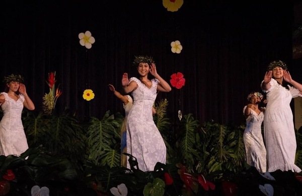 Kisa Matlin performs a traditional Hawai'ian dance with a group.